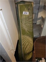 2 USED GREEN PATIO RUGS