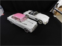 Two vintage metal cars: pink hard top - white