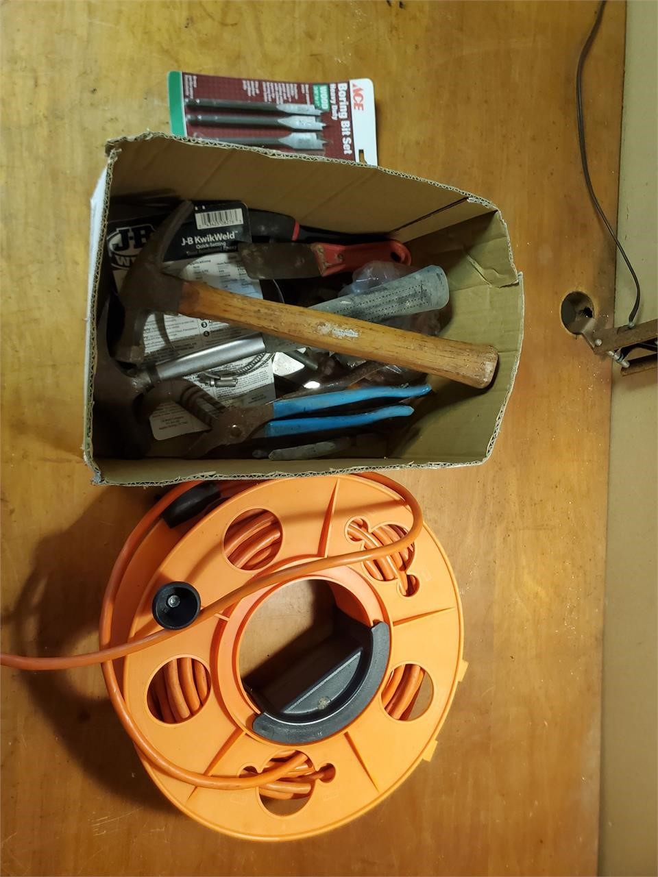 Extension cord on reel and assorted tools