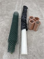 Roll of poly tarp, snow fence, clay pipe
