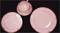 Two four-piece china place settings marked