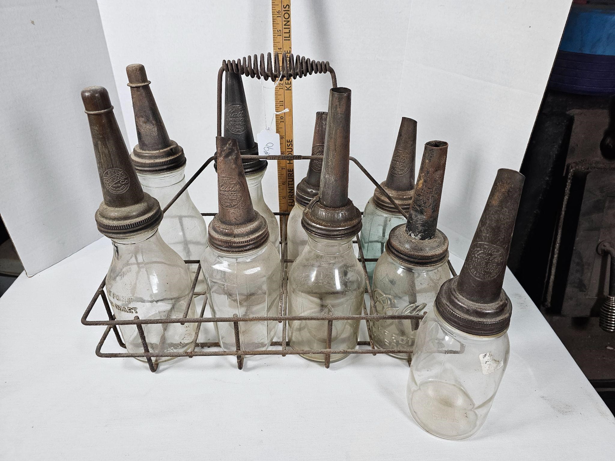 Vintage oil bottles with spouts in carrier