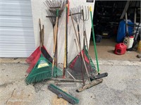 Lot of assorted rakes and brooms