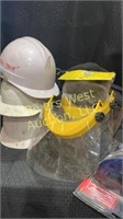 Assorted hard hats and face shields