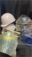 Assorted hard hats and face shields