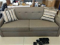 New Gray colored sofa appears to be Store return