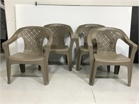 Four stackable plastic patio chairs