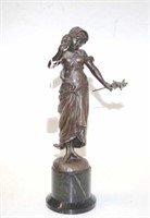 Bronzed figure of standing woman with mask