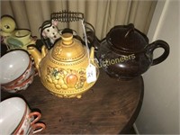 TWO POTTERY TEA POTS AND CANDLEHOLDER