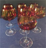 Seven red wine glasses, clear stems