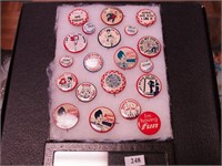 Container of vintage comic pinbacks