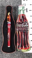 coca cola tin with pen