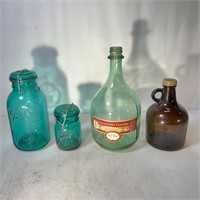 Assortment of Glass Jars and Wine Glass Bottle