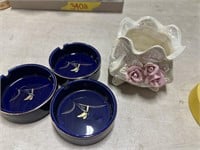 Three blue ashtrays and rose trinket holder