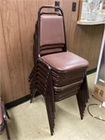 Eight padded stackable chairs