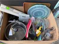 Box of kitchen items with some pans