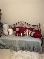 Daybed with decorative pillows and linens