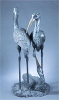Large verdigris bronze crane sculptural group.
