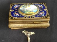 Vintage brass enameled mechanical music box with