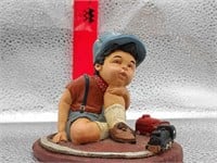 Little Boy with Toy Train Figure
