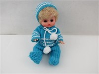 Baby in Blue & Crocheted Outfit