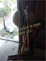 Assorted brooms and mops