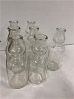 7 glass milk bottles. No markings