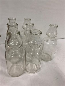 7 glass milk bottles. No markings