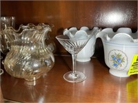 Top shelf of China cabinet, containing  lamp shade