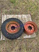 2 rims one with TIRE 10–16.5 skid steer tire