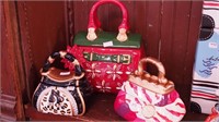 Three colorful purse cookie jars, one large and