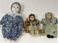 One porcelain doll, and two ceramic dolls