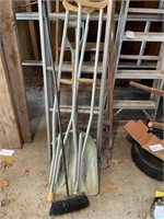 Scoop shovel, crutches and broom