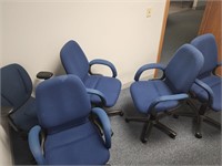 5 blue office chairs with rollers