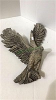 Concrete wall hanging hawk with fish catch