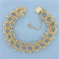 Wide Twisting Loop Rope Charm Bracelet in 14k Yell