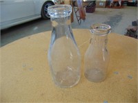 2 embossed milk bottles