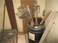 55-gal plastic barrel w/hoe, rake, shovel, misc