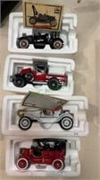 Four model cars in foam boxes with their cards.
