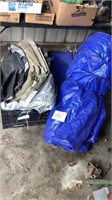 2 plastic crates containing tarps and moving