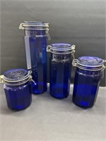 4 blue glass snap lid canister set 13"-6"