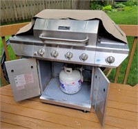Nexgrill gas grill with cover and tank.