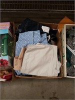 Box of clothes with tags