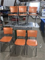 A vintage chrome table and six chrome chairs -