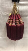 13 tassels. Tied with gold. 10” total length