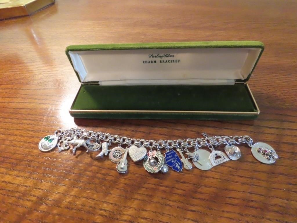 Sterling silver charm bracelet & 16 charms.