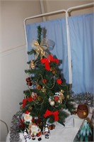 Small tree and decorations on and under.