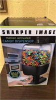 Sharper image motion activated candy dispenser