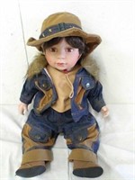 Porcelain boy doll. 15" sitting down. Denim