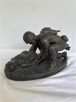 Military statue medic helping wounded